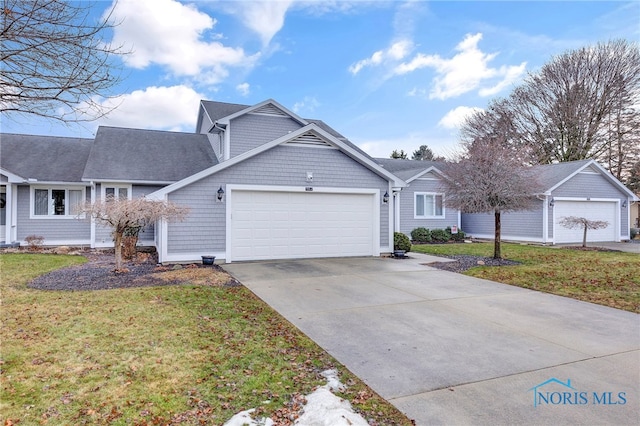 view of front of property featuring a garage and a front yard