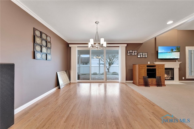 unfurnished dining area with crown molding, a notable chandelier, and light hardwood / wood-style flooring