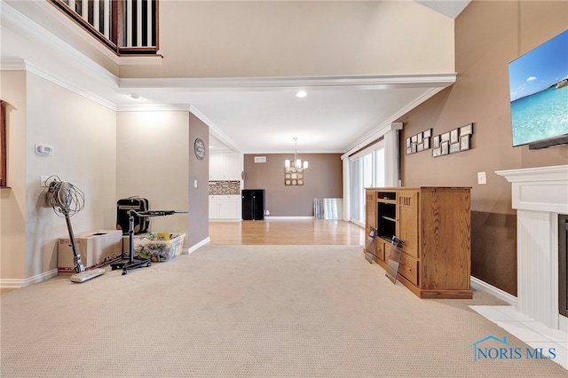 interior space featuring an inviting chandelier, light colored carpet, and ornamental molding