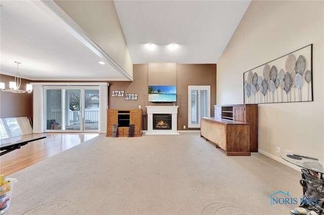 unfurnished living room featuring light carpet and an inviting chandelier