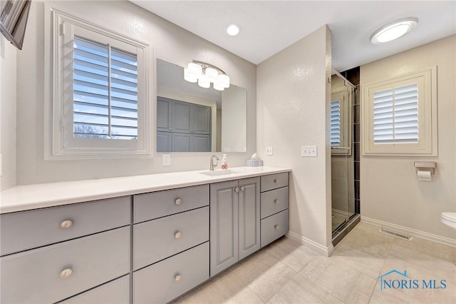 bathroom with vanity and a shower with shower door