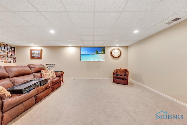 living room with carpet flooring and a drop ceiling