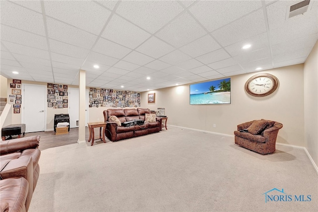 carpeted living room with a paneled ceiling