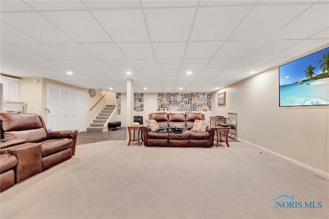 living room with carpet flooring and a drop ceiling