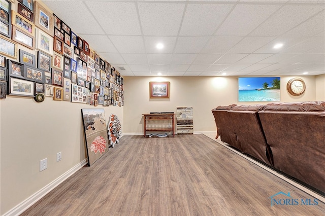 game room featuring a paneled ceiling and wood-type flooring