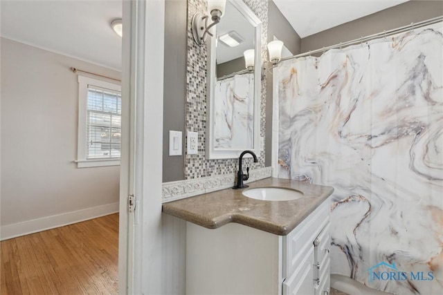 bathroom featuring vanity, hardwood / wood-style flooring, tasteful backsplash, and a shower with curtain