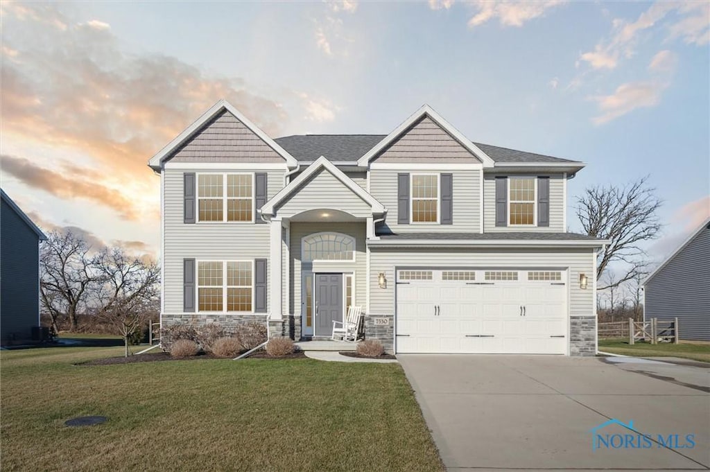 view of front of house featuring a lawn and a garage