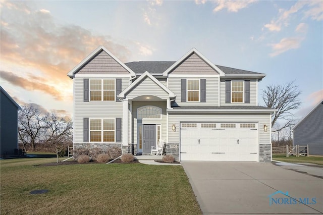 view of front of house featuring a lawn and a garage