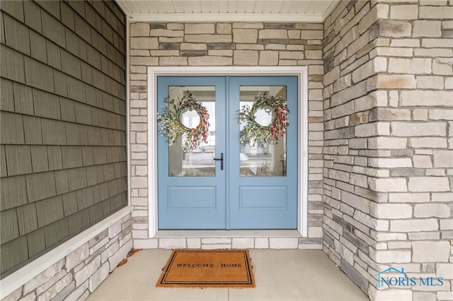 view of exterior entry featuring french doors