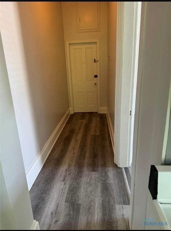 corridor featuring dark hardwood / wood-style floors