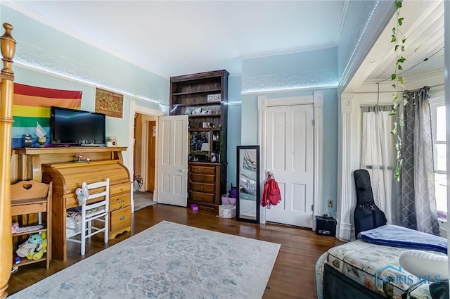 bedroom featuring ornamental molding and dark hardwood / wood-style flooring