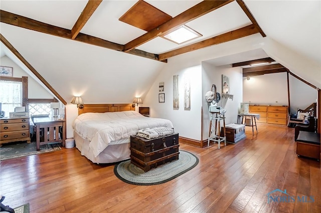 bedroom featuring lofted ceiling and dark hardwood / wood-style flooring