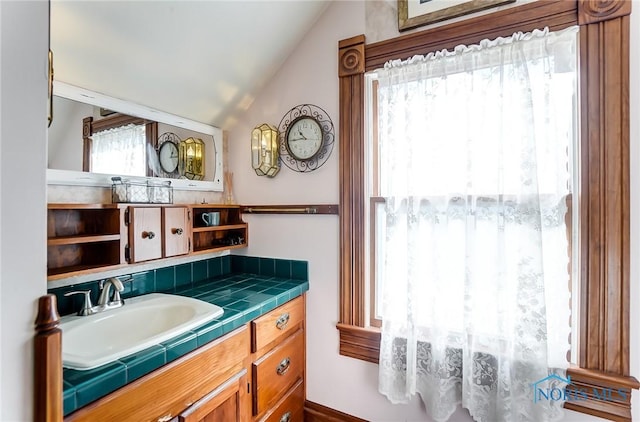 bathroom featuring lofted ceiling and vanity