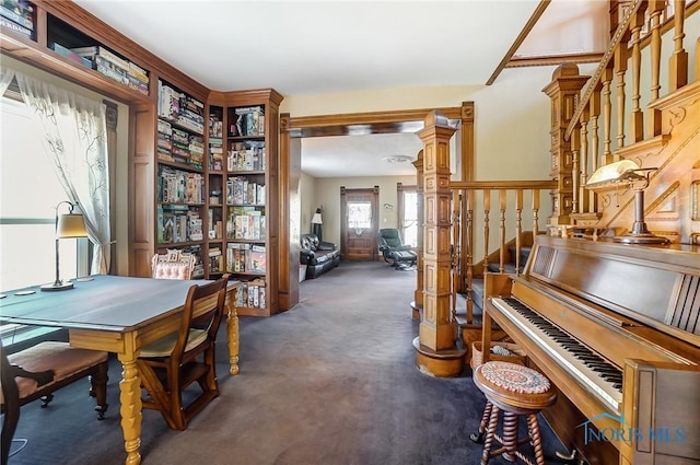 miscellaneous room featuring dark colored carpet