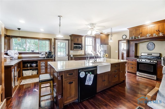 kitchen featuring sink, stainless steel appliances, dark hardwood / wood-style floors, and pendant lighting