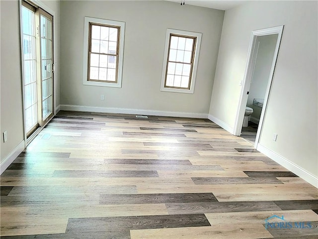 unfurnished room with light wood-type flooring