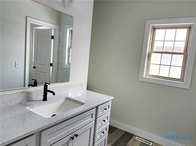 bathroom featuring wood-type flooring and vanity