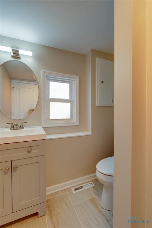 bathroom featuring vanity and toilet