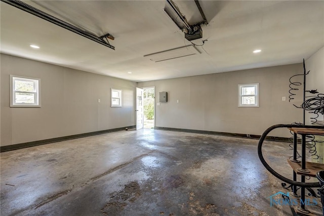 garage with electric panel and a garage door opener