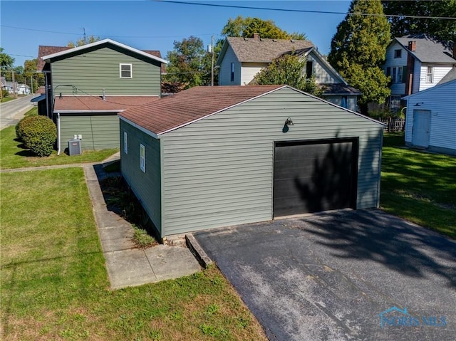 exterior space featuring a garage and a yard