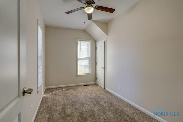 empty room featuring ceiling fan and light carpet