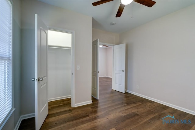 unfurnished bedroom with a closet, ceiling fan, and dark wood-type flooring