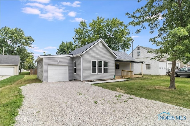 view of front of property with a garage and a front lawn