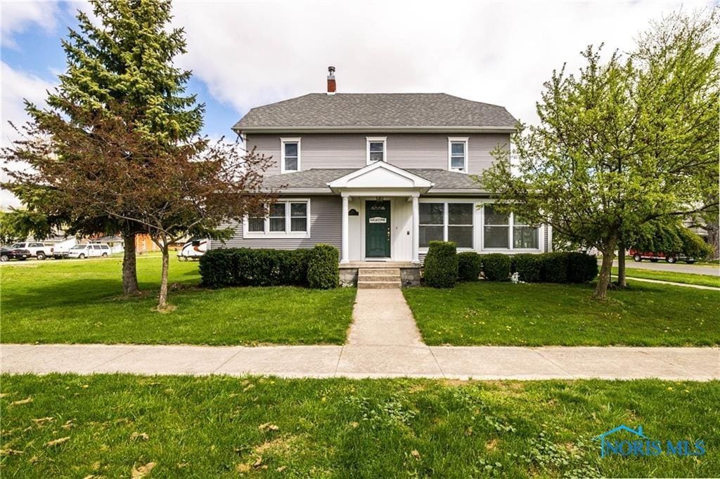 front facade with a front lawn