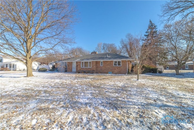 view of snow covered rear of property