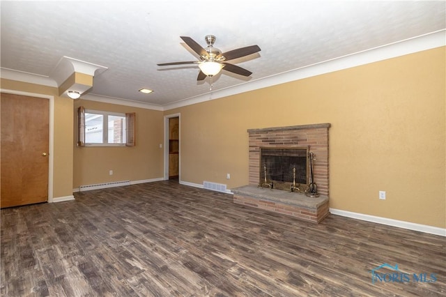 unfurnished living room with dark hardwood / wood-style flooring, a baseboard heating unit, a fireplace, and a textured ceiling