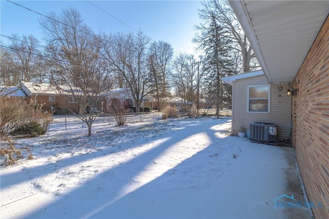 yard layered in snow with cooling unit