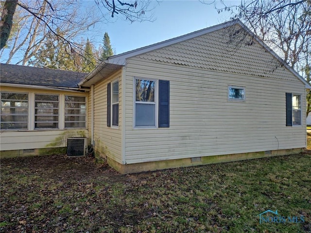 view of side of home featuring central AC unit