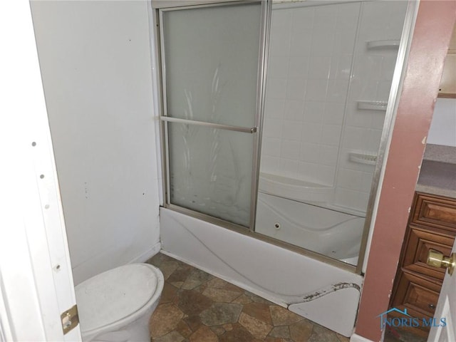 bathroom with bath / shower combo with glass door and toilet