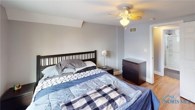 bedroom featuring ceiling fan, connected bathroom, and hardwood / wood-style floors