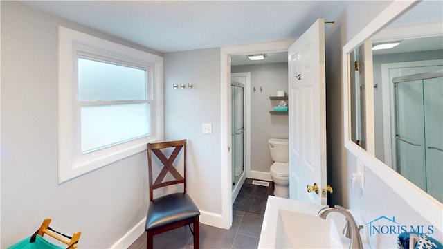 bathroom with toilet, tile patterned floors, and an enclosed shower