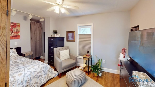 bedroom with ceiling fan and wood-type flooring