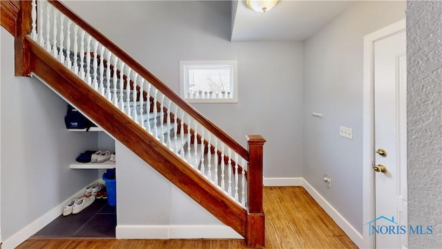 staircase with hardwood / wood-style floors