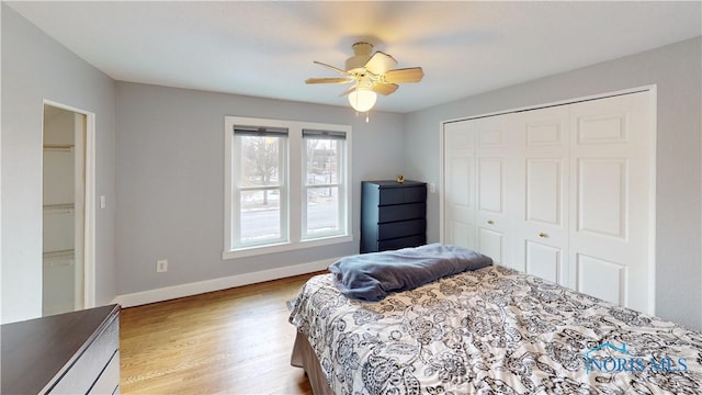 bedroom featuring ceiling fan, a closet, and light hardwood / wood-style floors