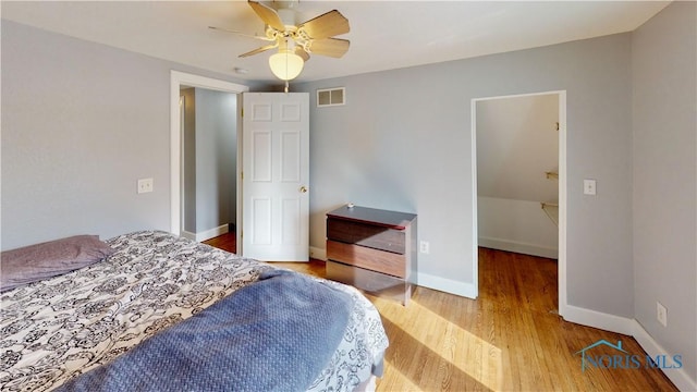 bedroom with ceiling fan and wood-type flooring