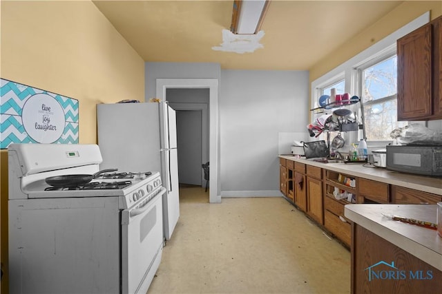 kitchen with sink and white gas range