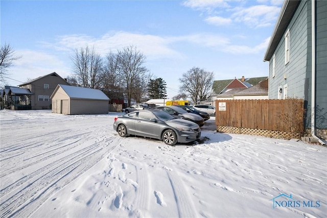 yard layered in snow with a storage unit