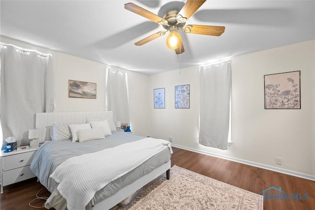 bedroom with dark wood-type flooring and ceiling fan