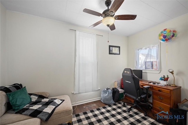 home office featuring dark hardwood / wood-style flooring and ceiling fan