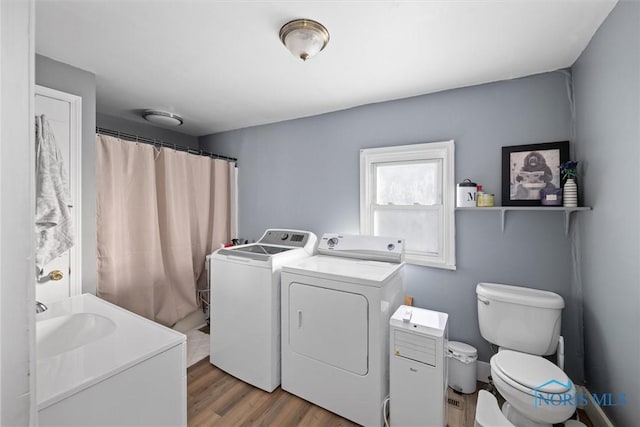 bathroom featuring vanity, hardwood / wood-style floors, independent washer and dryer, and toilet