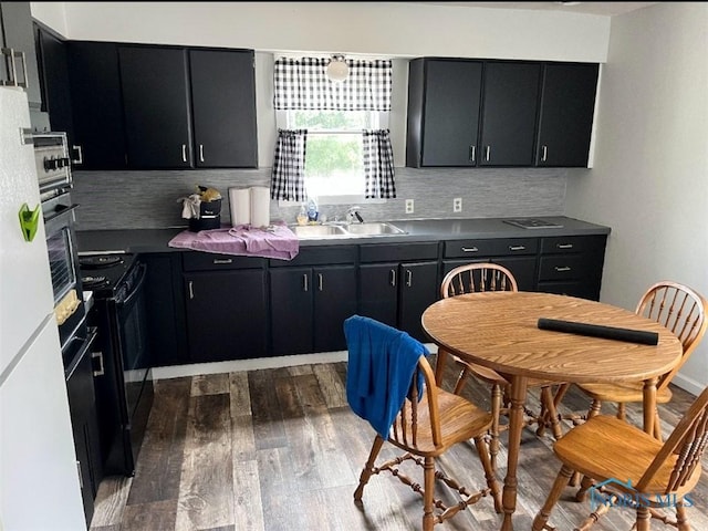 kitchen with sink, electric range, dark hardwood / wood-style flooring, and decorative backsplash