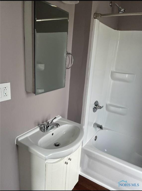 bathroom with vanity, tub / shower combination, and wood-type flooring