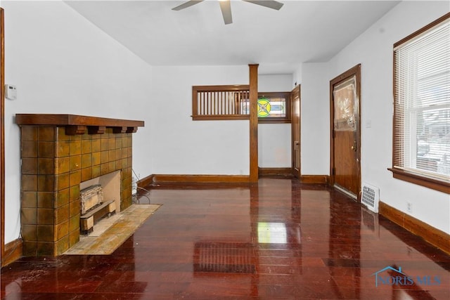 living room featuring ceiling fan and dark hardwood / wood-style floors