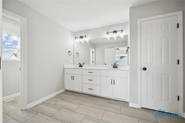 bathroom featuring ceiling fan and vanity