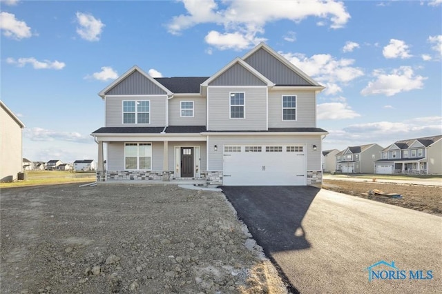 view of front of house with a garage and covered porch