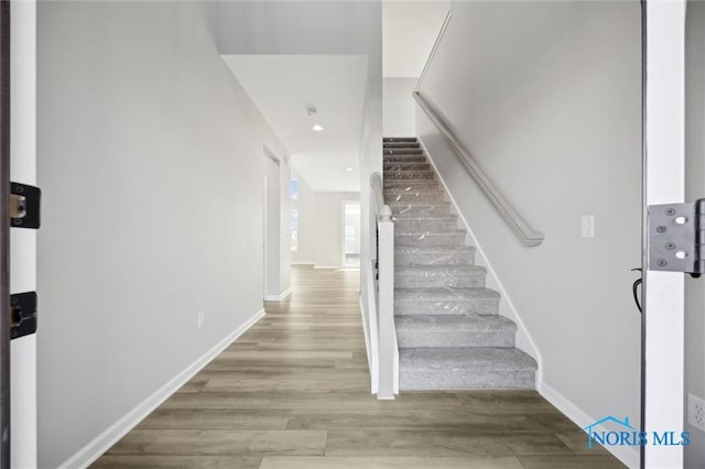 stairs with hardwood / wood-style floors